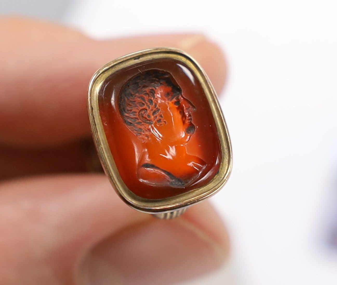 A Victorian yellow metal overlaid seal and and intaglio carnelian set seal, 21mm and a yellow metal and agate set brooch.